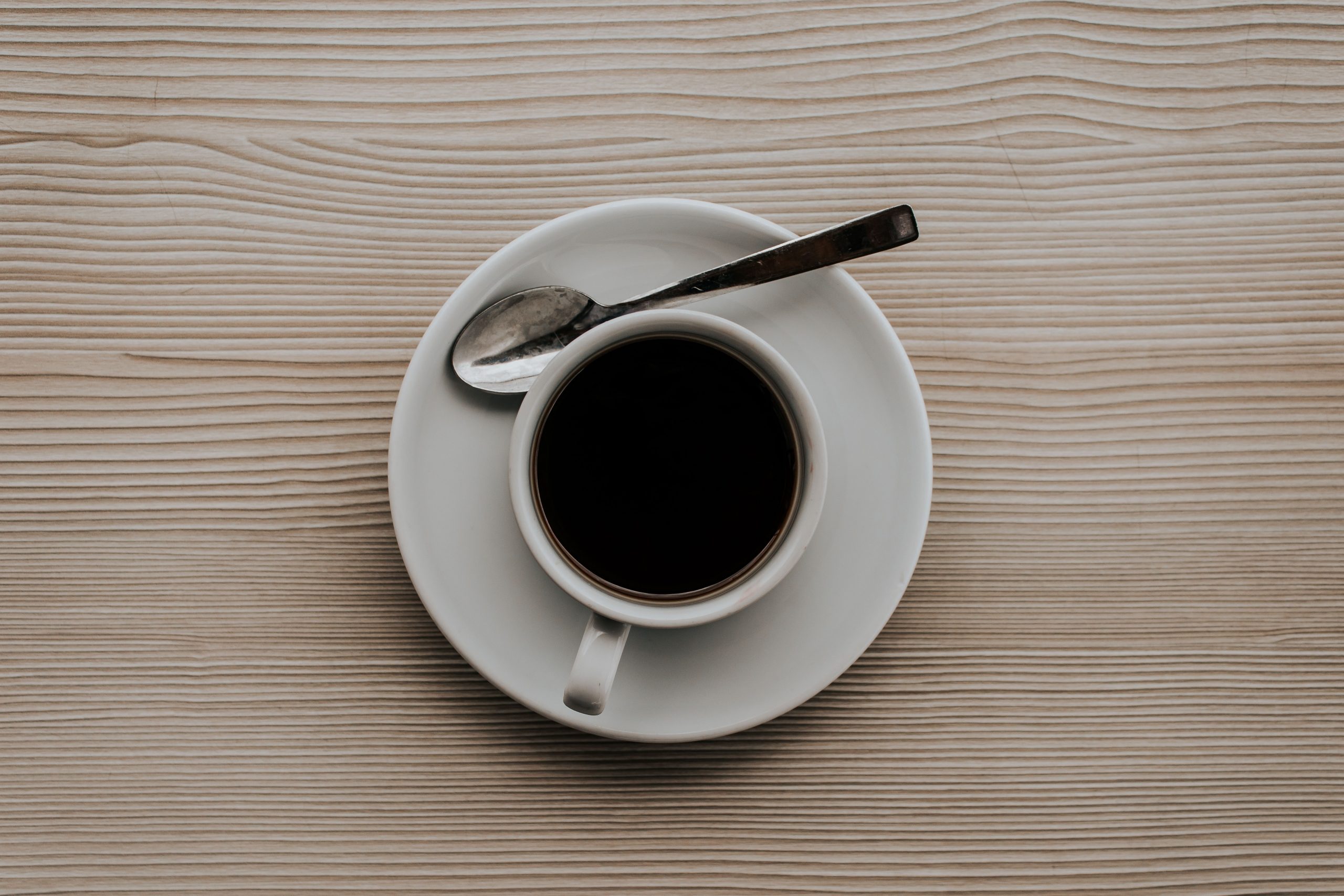 Mug of black coffee on table